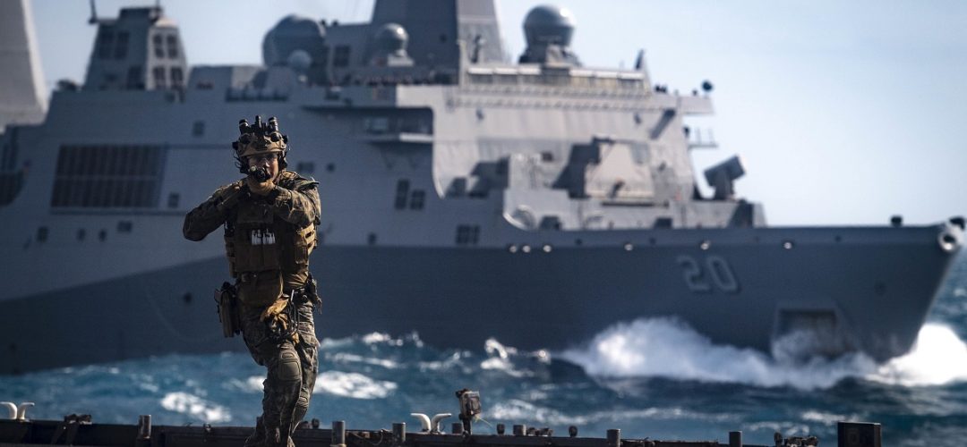 190706-N-WI365-3028 CORAL SEA (July 07, 2019) – A Force Reconnaissance Marine with the 31st Marine Expeditionary Unit (MEU) clears the flight deck of the amphibious dock landing ship USS Ashland (LSD 48) during a visit, board, search and seizure (VBSS) training exercise with the amphibious transport dock ship USS Green Bay (LPD 20). Ashland, part of the Wasp Amphibious Ready Group, with embarked 31st Marine Expeditionary Unit (MEU), is operating in the Indo-Pacific region to enhance interoperability with partners and serve as a ready-response force for any type of contingency, while simultaneously providing a flexible and lethal crisis response force ready to perform a wide range of military operations. (U.S. Navy photo by Mass Communication Specialist 2nd Class Markus Castaneda)