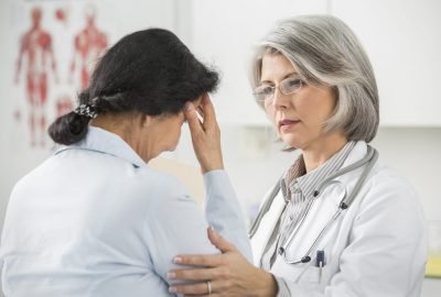 Doctor examining patient in office